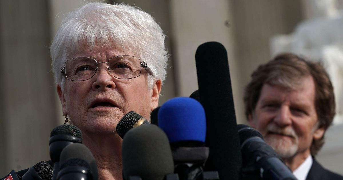 Floral artist Barronelle Stutzman, left, speaks to members of the media in front of the U.S. Supreme Court as cake artist Jack Phillips, right, looks on Dec. 5, 2017, in Washington, D.C.