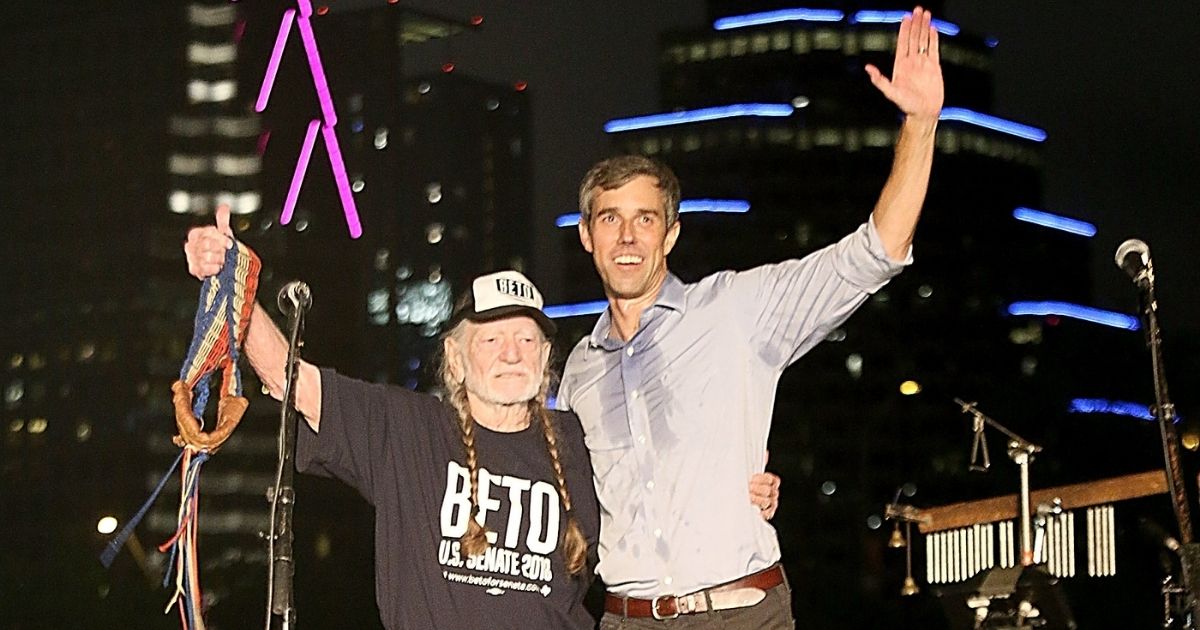 Former Texas Rep. Beto O'Rourke joins country music legend Willie Nelson on stage during a concert in support of O'Rourke's campaign for U.S. Senate at Auditorium Shores in Austin on Sept. 29, 2018.