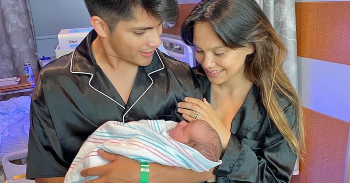 Parents Sergio Mancera and Kaitlyn Fullerton look at their son, Callihan, who was unexpectedly born in a Texas gas station bathroom during a road trip.