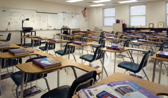 An empty classroom is seen in the stock image above.