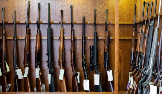 Guns are displayed in a store in this stock image.