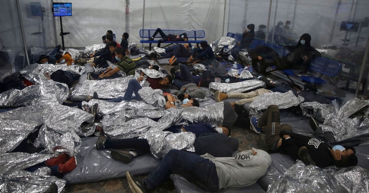 Children rest inside a Department of Homeland Security holding facility in Donna, Texas, on March 30, 2021.
