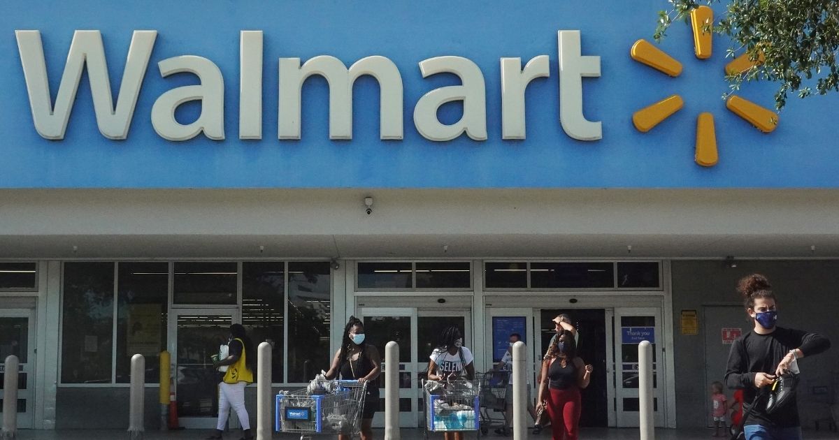 People walk out of a Walmart store in Hallandale Beach, Florida, on May 18, 2021.