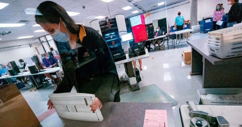 A poll worker sorts ballots inside the Maricopa County Election Department in Phoenix on Nov. 5, 2020.