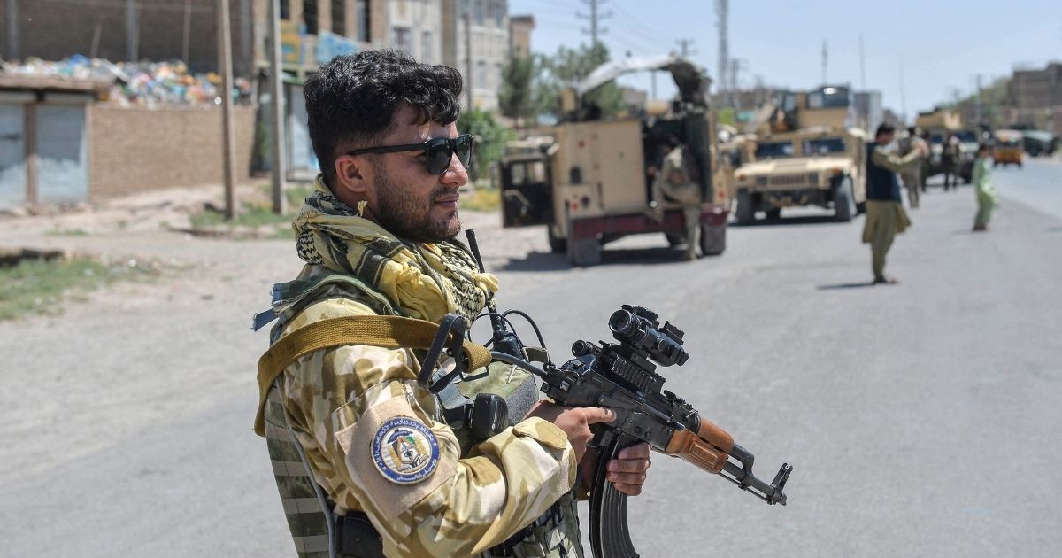 An Afghan National Army commando stands guard along the road in Enjil district of Herat province on Sunday as skirmishes between Afghan troops and Taliban forces continue.