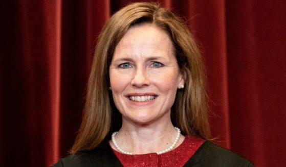 Associate Justice Amy Coney Barrett stands during a group photo of the justices at the Supreme Court in Washington on April 23.