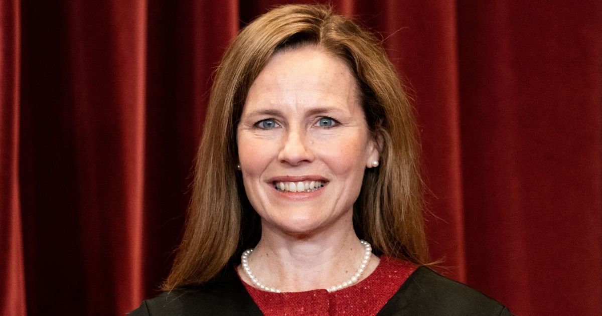 Associate Justice Amy Coney Barrett stands during a group photo of the justices at the Supreme Court in Washington on April 23.