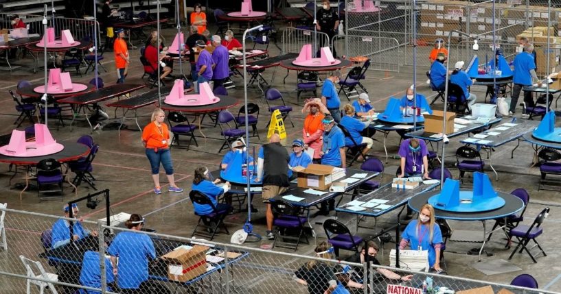 Maricopa County ballots cast in the 2020 general election are examined and recounted by contractors working for the Florida-based company Cyber Ninjas at Veterans Memorial Coliseum in Phoenix on May 6, 2021.
