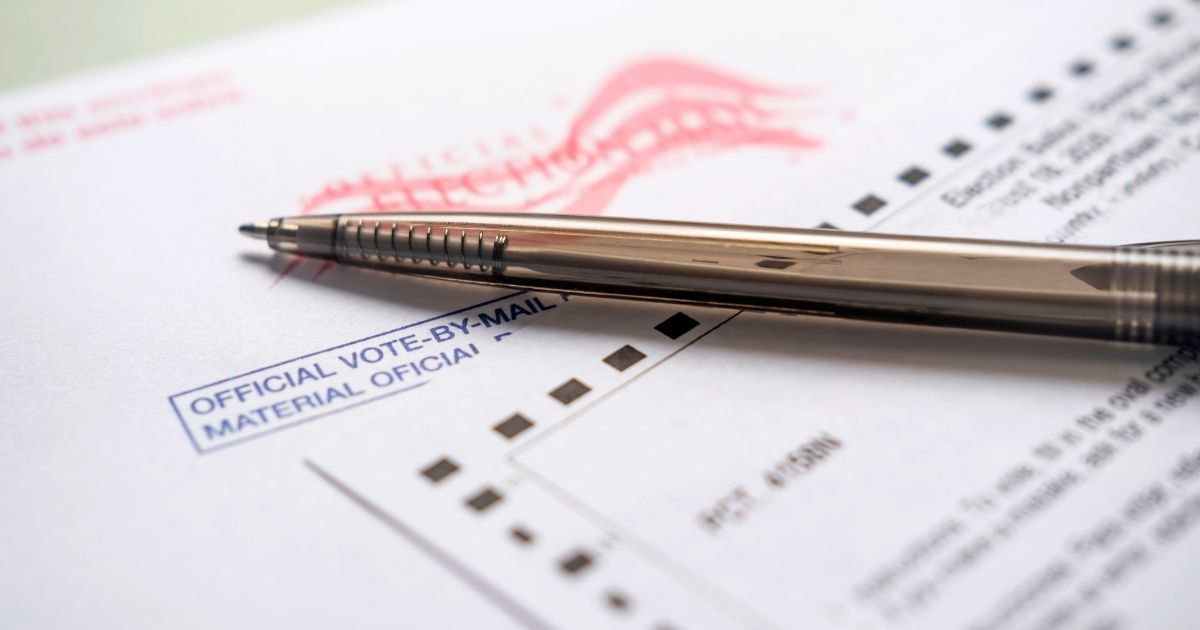 A pen sits on top of a ballot
