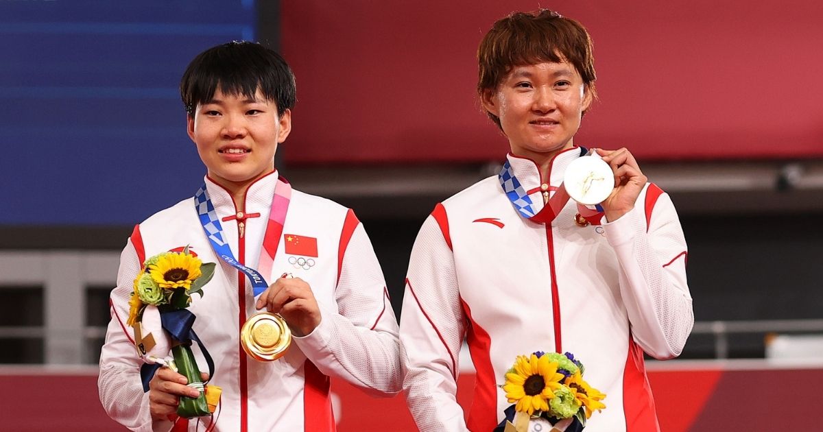 Bao Shanju and Zhong Tianshi of China pose with their gold medals after winning the women's team sprint track cycling finals at the Tokyo Olympics at Izu Velodrome on Monday in Izu, Shizuoka, Japan.