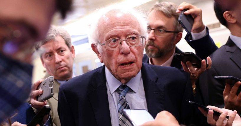 Independent Sen. Bernie Sanders of Vermont talks to reporters as he walks to a vote at the U.S. Capitol on July 21, 2021, in Washington, D.C.