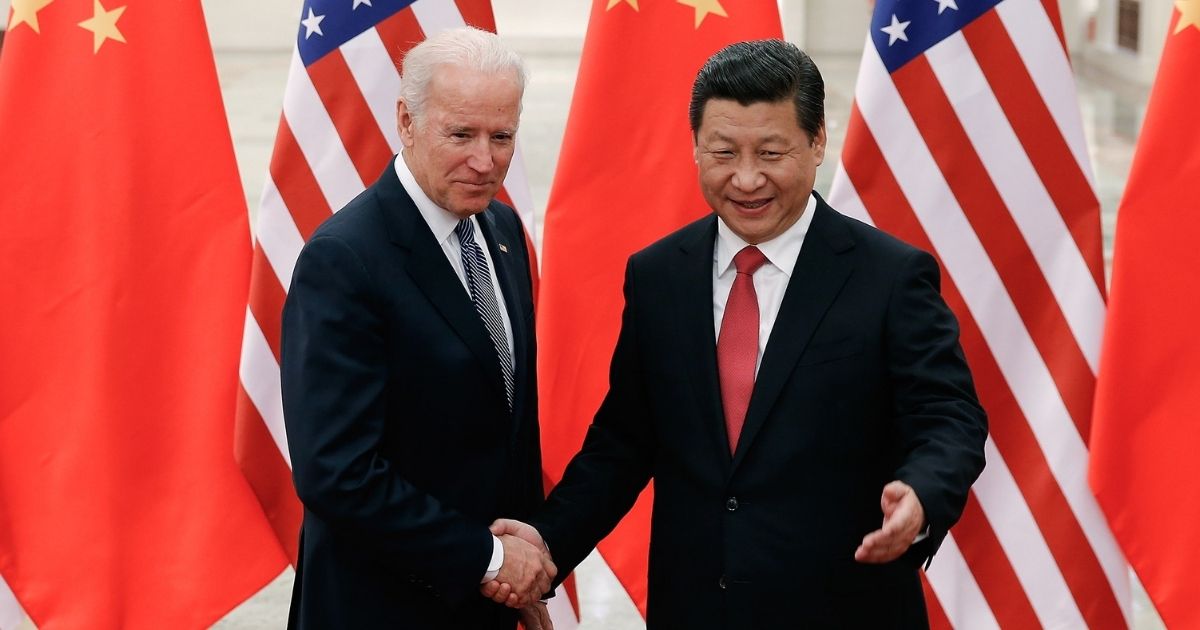 Chinese President Xi Jinping, right, shakes hands with then-U.S. Vice President Joe Biden inside the Great Hall of the People on Dec. 4, 2013, in Beijing, China.