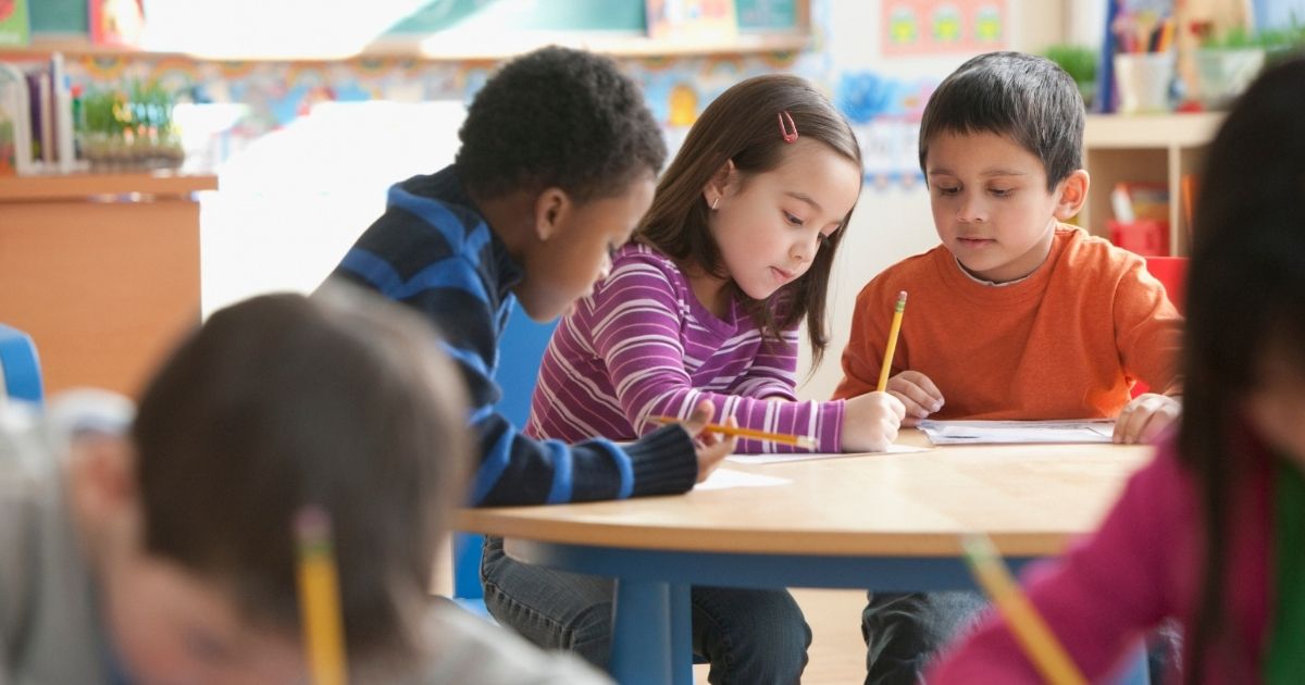 This stock image portrays a group of children sitting in class. The Centers for Disease Control and Prevention this week called out an unvaccinated California teacher after a COVID-19 outbreak in Marin County in May.