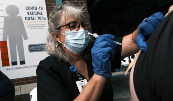 A nurse administers the COVID-19 vaccine at a baseball game on Aug. 5, 2021, in Springfield, Missouri.