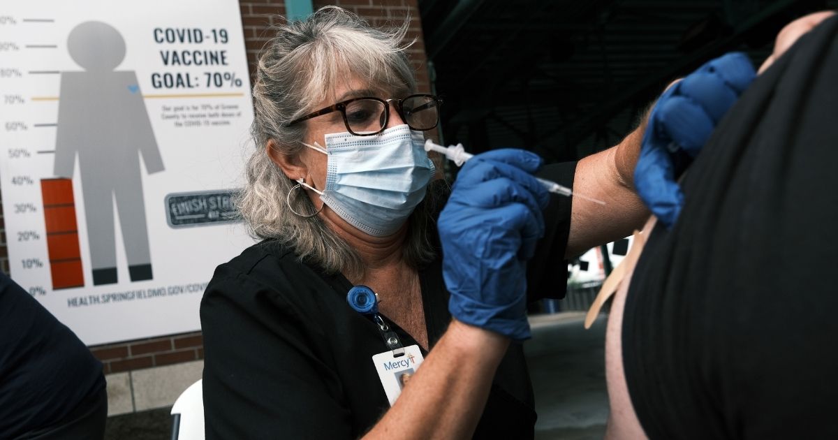 A nurse administers the COVID-19 vaccine at a baseball game on Aug. 5, 2021, in Springfield, Missouri.