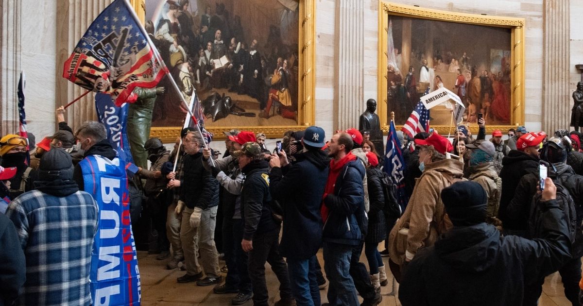 Protesters stand in the Rotunda during the Capitol incursion on Jan. 6 in Washington.