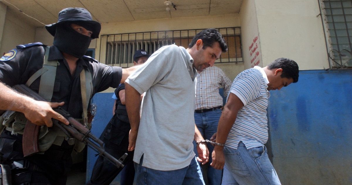 Two alleged members of the Mexican Sinaloa Cartel are escorted by Nicaraguan policemen on April 16, 2007.