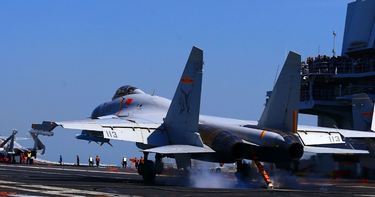 A Chinese J15 Jet takes off from an aircraft carrier in the China Sea during a military drill.