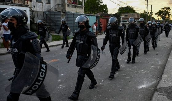 Riot police walk the streets after a demonstration against the government of President Miguel Díaz-Canel in Havana on July 12, 2021.