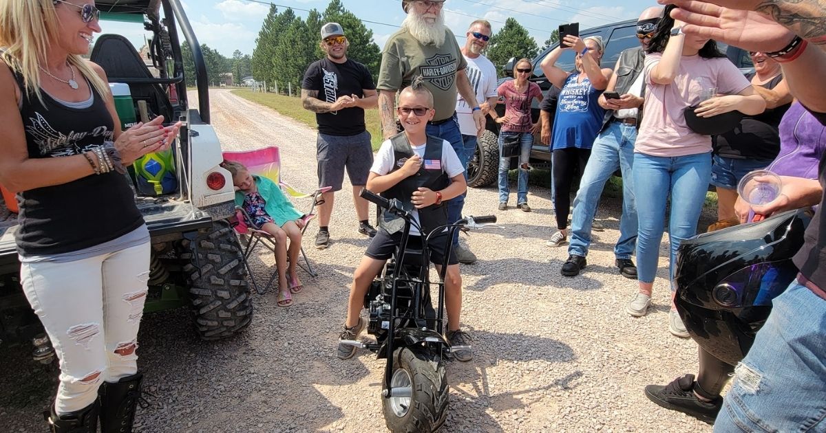 Wyatt Dennis, an 8-year-old from South Dakota who ran a lemonade stand to raise money for college and charity, tests out the dirt bike he was gifted.