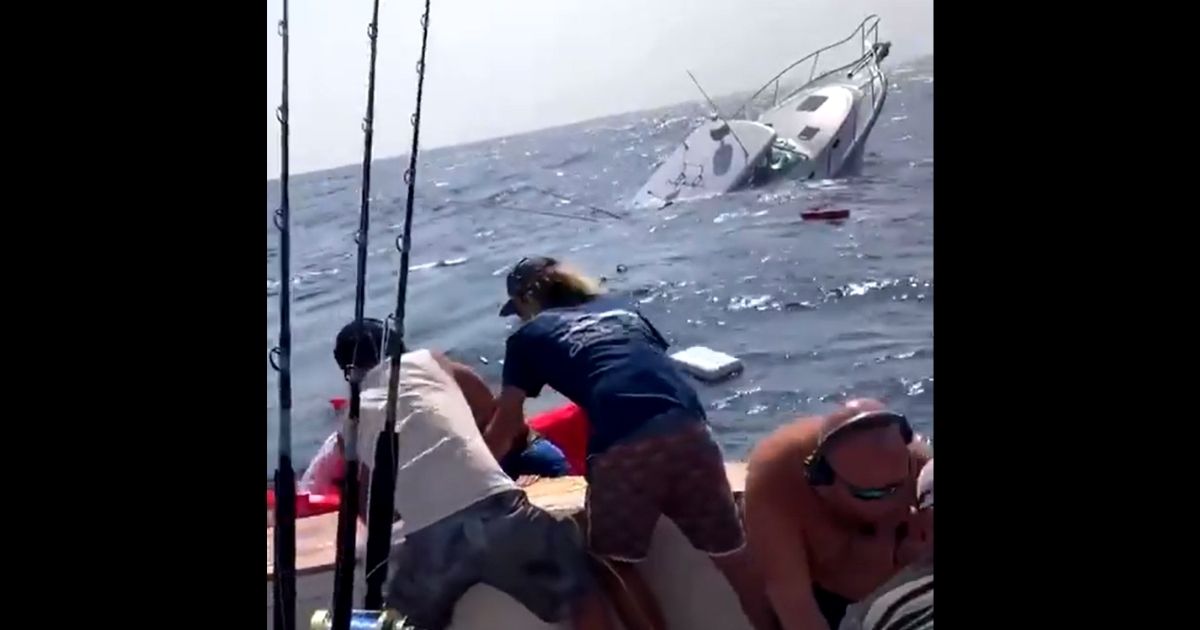 The crew of the Fishbone helps rescue those on the Knot Stressin after it took on water and started sinking during the White Marlin Open in Ocean City, Maryland.