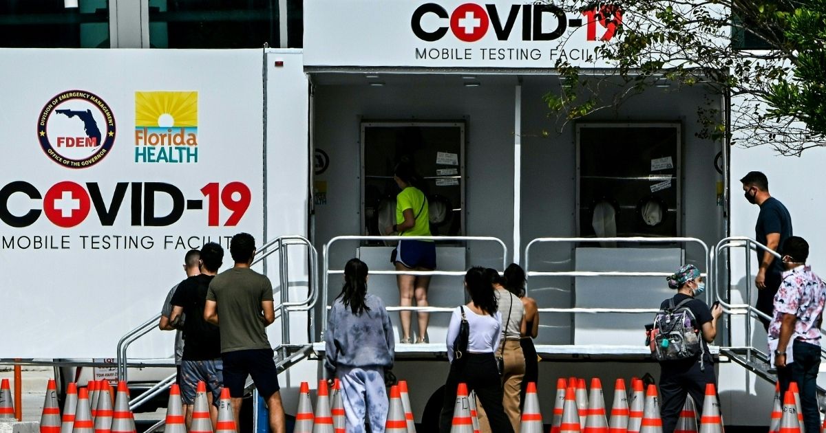 A group of Floridians line up outside of a COVID-19 testing site in Miami Beach, Florida.