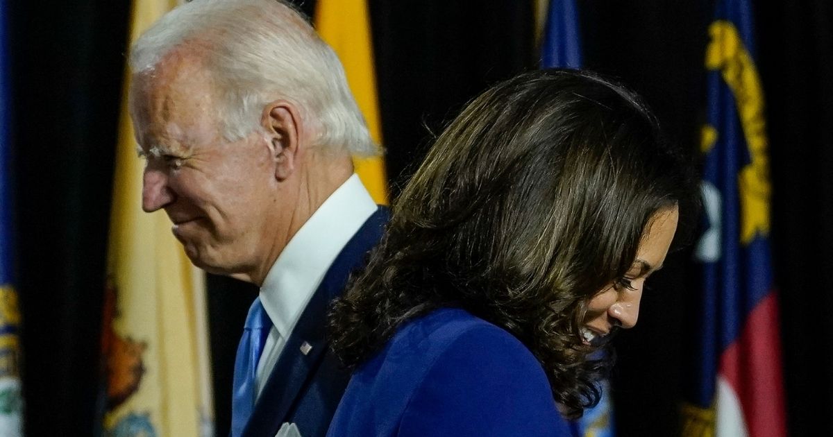 Then-presidential candidate Joe Biden, left, invites then-vice presidential candidate Kamala Harris to the stage to give remarks.