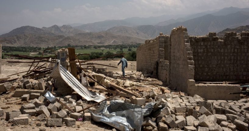 A boy walks through buildings damaged from fighting on July 15, 2017, in Shadal Bazaar, Afghanistan. People are slowly returning to the recently liberated area, which had previously been a front line of fighting against the Islamic State of Iraq and Syria - Khorasan (ISIS-K) in Achin District of Nangarhar Province.