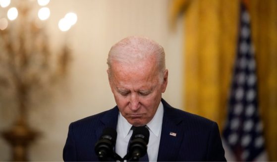 President Joe Biden bows his head in a moment of silence as he speaks about the situation in Kabul, Afghanistan, from the East Room of the White House on Thursday in Washington, D.C.