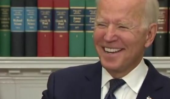 President Joe Biden laughs in response to a reporter at a media briefing on Sunday.