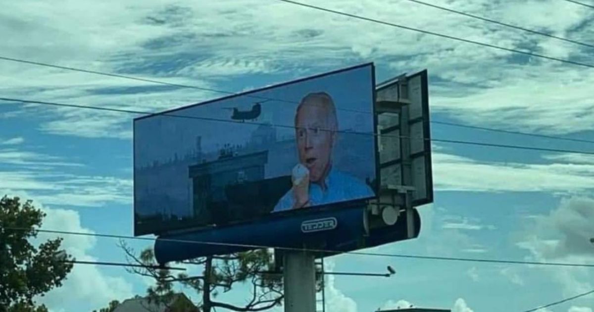 A billboard in Wilmington, North Carolina, depicts President Joe Biden eating an ice cream cone, as the evacuation of Afghanistan goes on in the background.