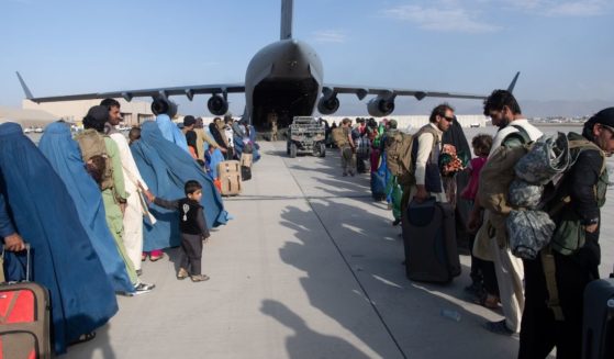 In this handout provided by U.S. Central Command Public Affairs, U.S. Air Force loadmasters and pilots assigned to the 816th Expeditionary Airlift Squadron load passengers aboard a U.S. Air Force C-17 Globemaster III in support of the Afghanistan evacuation at Hamid Karzai International Airport on Tuesday in Kabul, Afghanistan.