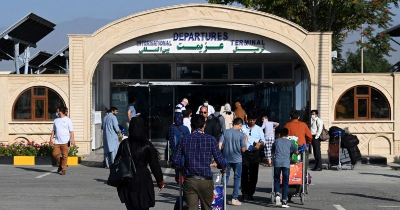 Passengers queue to enter the departures terminal of Hamid Karzai International Airport in Kabul on July 17, 2021.