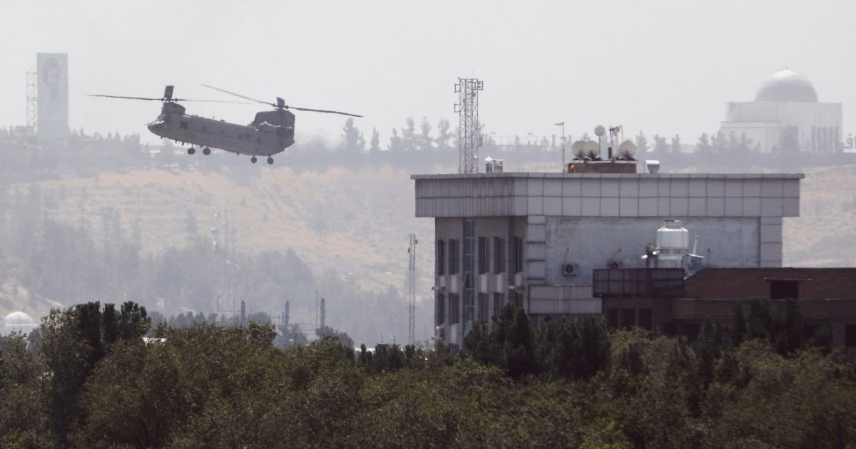 A Chinook helicopter flies near the U.S. Embassy in Kabul, Afghanistan, on Sunday.