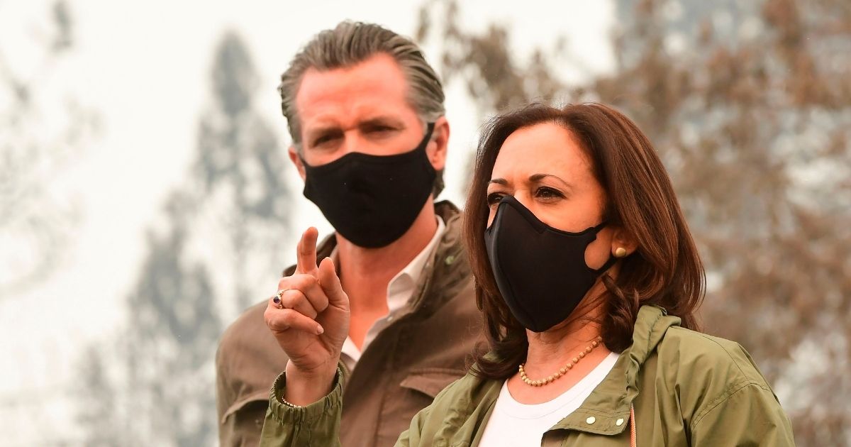 Then-Democratic vice presidential nominee Kamala Harris, right, speaks next to California Gov. Gavin Newsom as they visit Pine Ridge Elementary School in an unincorporated area of Fresno, California, on Sept. 15, 2020.
