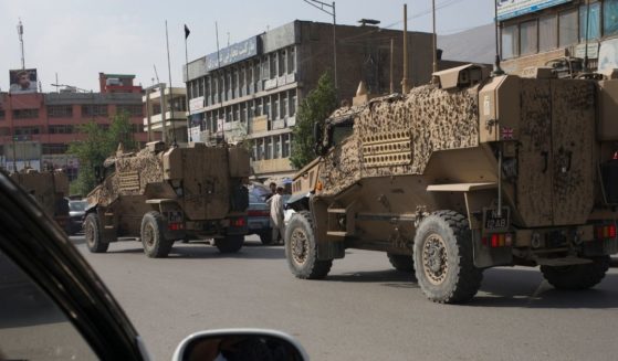 A convoy of British Army Mine Resistant Ambush Protected, or MRAPs, known as Foxhounds, works it's way through morning traffic jams in downtown Kabul on Aug. 29, 2016.