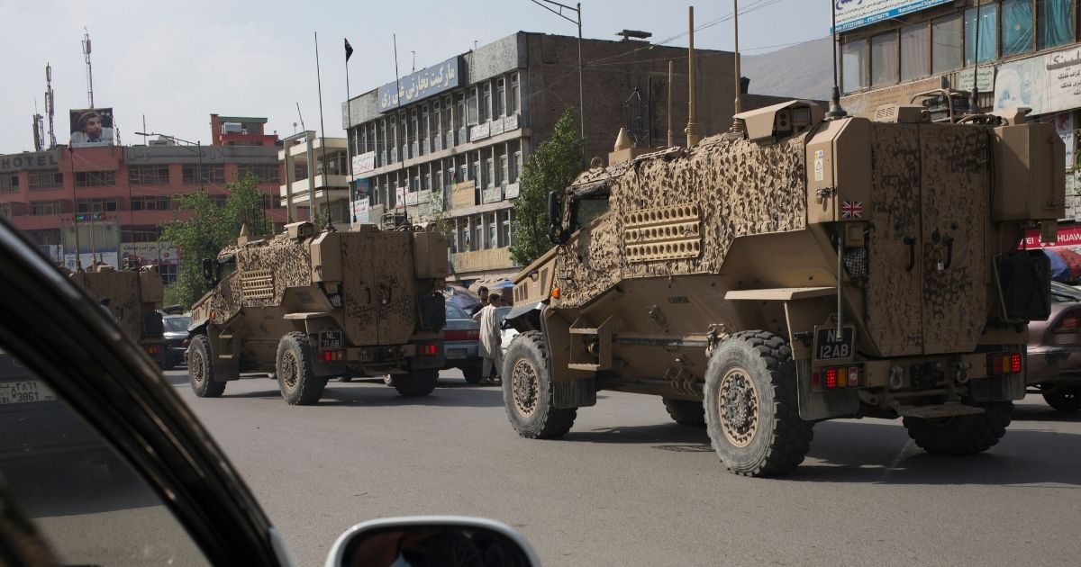 A convoy of British Army Mine Resistant Ambush Protected, or MRAPs, known as Foxhounds, works it's way through morning traffic jams in downtown Kabul on Aug. 29, 2016.