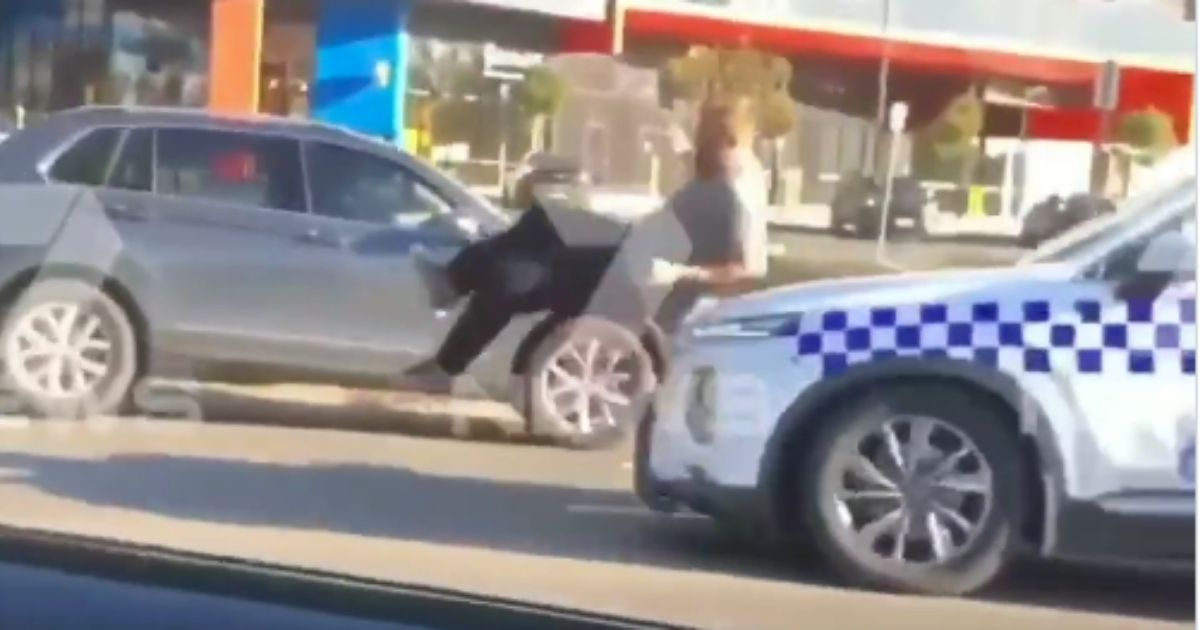 A man is hit by a police car during an altercation in Australia, as shown in a video posted on Sunday.