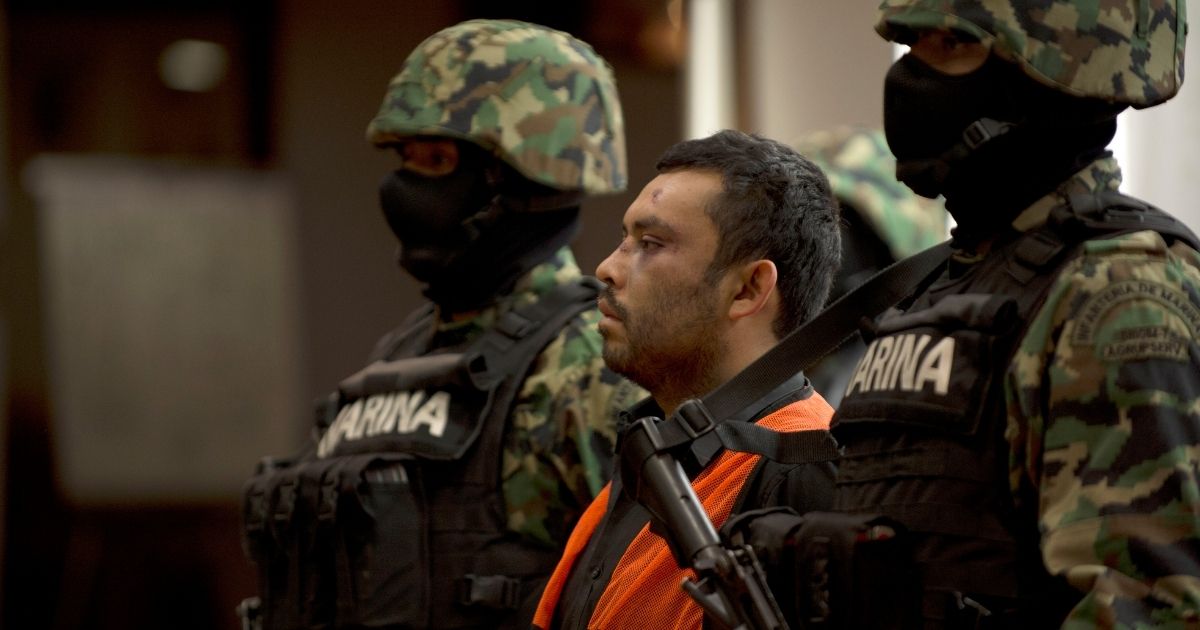 Mexican marines escort Marcos Jesus Hernandez Rodriguez, aka "El Chilango," the alleged leader of assassins and member of the Los Zetas drug cartel, in Veracruz state in Mexico City on May 11, 2012.