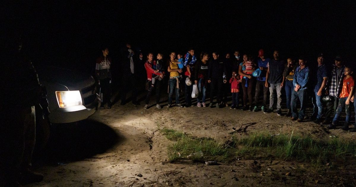 Migrant families line up after illegally crossing the U.S.-Mexico border into Roma, Texas, on July 9.