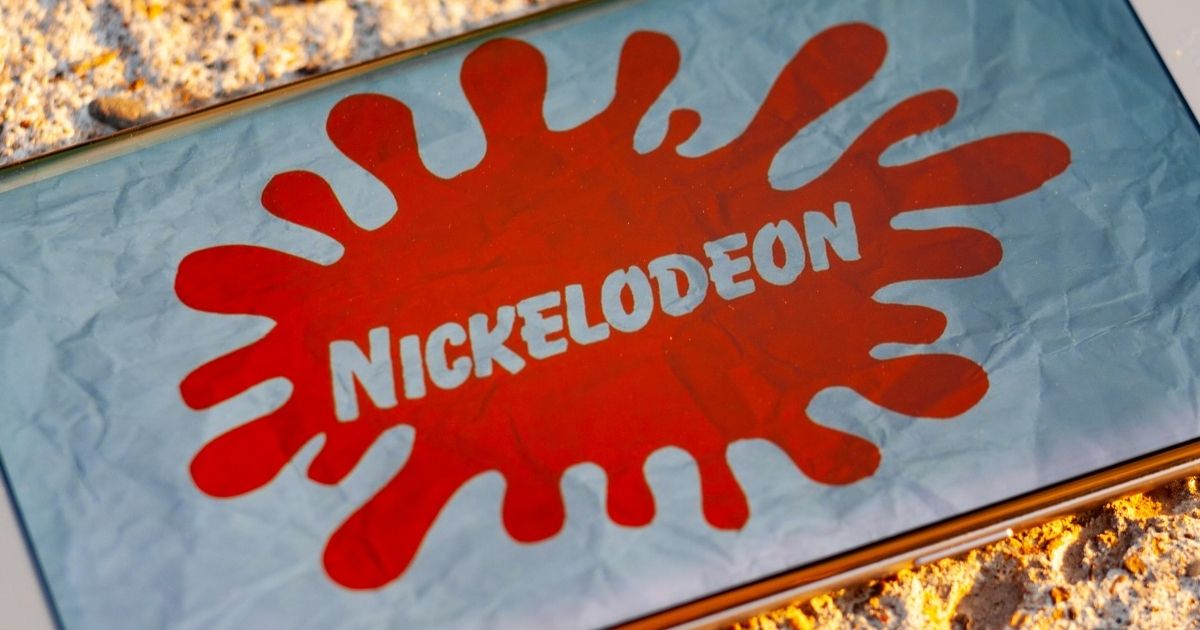The Nickelodeon logo is pictured on a smartphone in the stock image above.