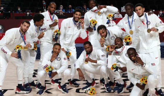 Members of the U.S. Olympic men's basketball team pose with their gold medals at the Tokyo Olympic Games at Saitama Super Arena on Saturday in Saitama, Japan. (