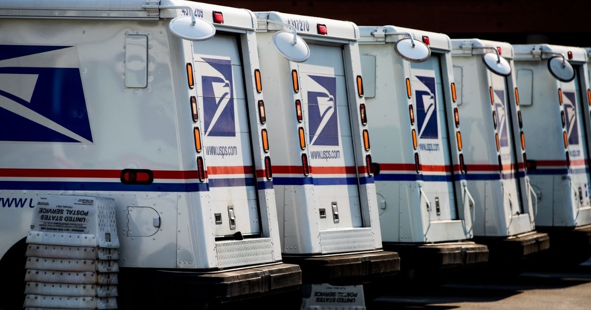 Mail trucks are seen at a post office in Los Angeles on Aug. 22, 2020.