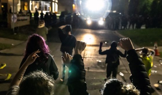 Protesters face off against a line of police officers at the Brooklyn Center Police Station in Minneapolis on April 11, 2021.