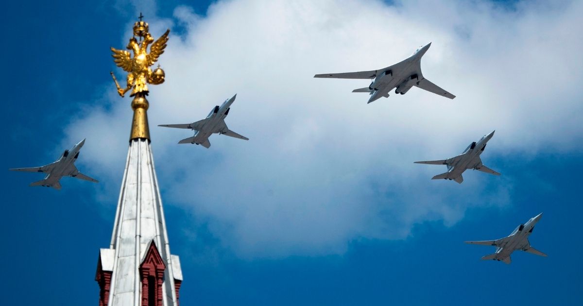 A Tupolev Tu-160 and Tu-22M3 military aircraft fly over Red Square during a military parade in Moscow on June 24, 2020.