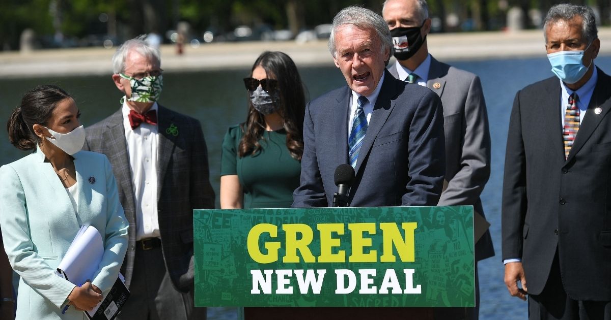 Massachusetts Democratic Sen. Ed Markey, center, and New York Democratic Rep. Alexandria Ocasio-Cortez, left, introduce the Green New Deal on the step of the U.S. Capitol on April 20, 2021.