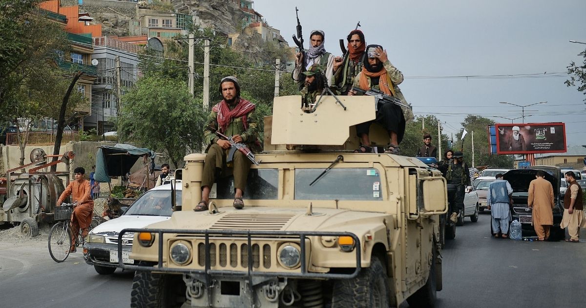 Taliban fighters atop a Humvee take part in a rally in Kabul on Tuesday.