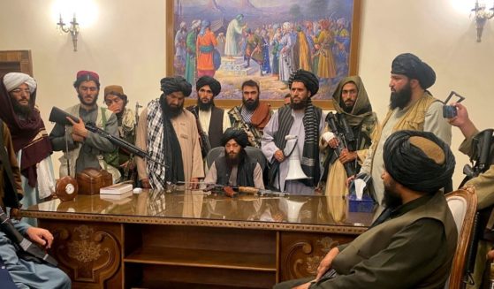 Taliban fighters take control of the Afghan presidential palace in Kabul on Sunday.