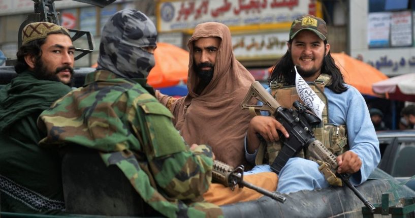 Taliban fighters patrol on a pick-up vehicle along in a street in Kabul on Tuesday after the U.S. pulled all its troops out of the country.