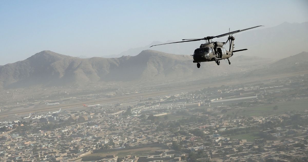 A Black Hawk helicopter flies over the city in Kabul, Afghanistan, on Oct. 3, 2014.